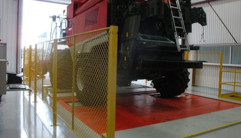 A large tractor is sitting in a warehouse.