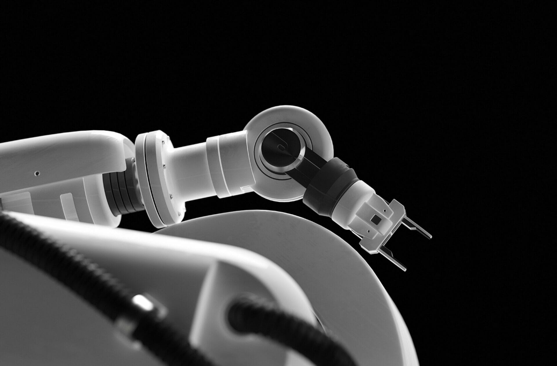A black and white image of a robotic arm.