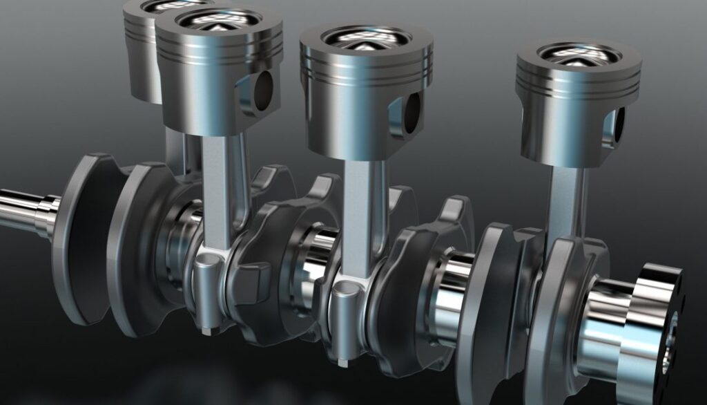 A set of engine pistons on a black background.