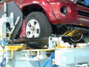 Automotive wheel aligner with robot toe set